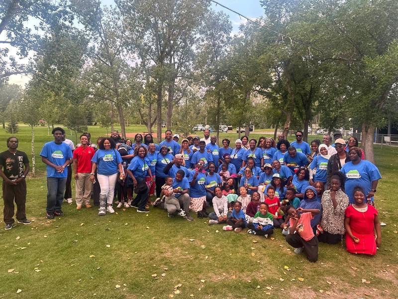 A large group of SALDAC members and families in blue T-shirts at the 2025 Picnic in the Park